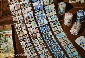 Detail view of vintage stamp-style washi tape with gold foil butterfly and floral designs