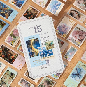 Close-up of vintage stamp-style stickers with gold foil details and floral patterns