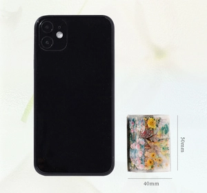 Detail of floral PET tape showing 50mm height next to a smartphone for size reference