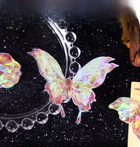 Macro detail of laser shell butterfly stickers with iridescent holographic texture