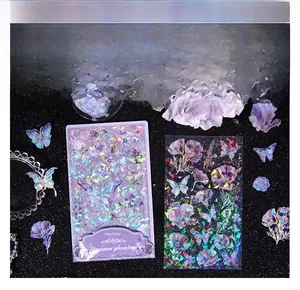 Detail of holographic butterfly and floral PET stickers with laser aurora effect on black