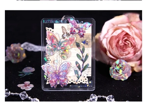 Macro detail of laser butterfly and floral stickers on decorative acrylic card holder