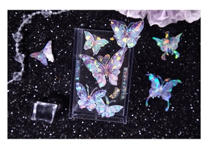 Detail of holographic butterfly stickers on crystal stand with a cosmic glitter background