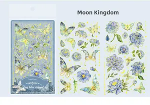 Close-up of blue butterfly stickers with floral patterns and gold foil edges decoration