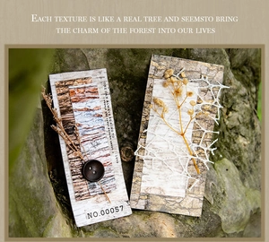 Detailed view of forest-themed craft cards with bark texture, dried flowers and button