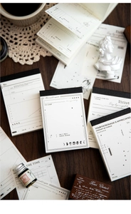Macro view of vintage minimalist memo pads with retro ticket designs and stationery