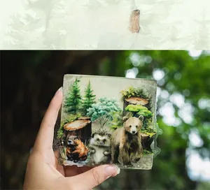 Detail showing forest animal stickers with watercolor bear and hedgehog illustrations