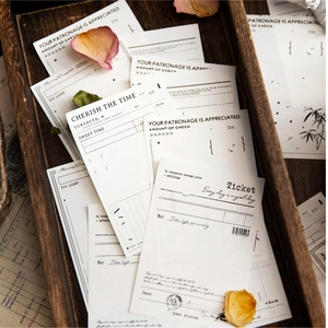Vintage aesthetic memo pads and decorative stationery cards on a rustic wooden tray