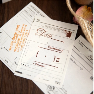 Vintage memo pads with literary English quotes on dark wood background for DIY scrapbooking
