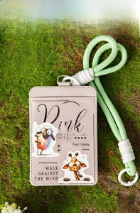Detail of faux leather card holder with cute animal stickers on natural moss background