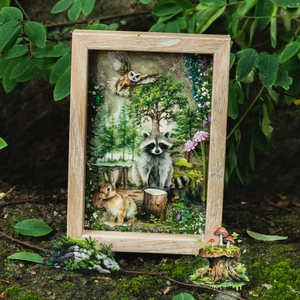 3D forest animal paper art in wood frame with raccoon and rabbit in nature setting