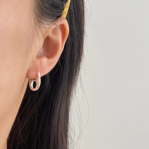 Minimalist 925 sterling silver pig nose hoop earrings worn on model for a modern look