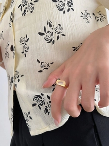 Close-up of 925 silver gold ring with white chalcedony worn on finger for casual style
