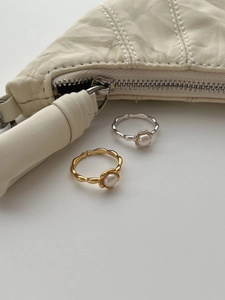 Detailed macro view of S925 silver sunflower rings with natural freshwater pearls