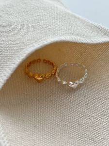 Detail of S925 sterling silver stamp on minimalist heart shaped adjustable rings