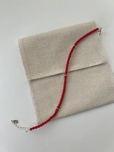 Detail of S925 sterling silver lobster clasp and extension chain on red beaded bracelet