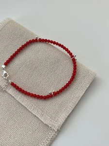 Close-up of S925 sterling silver red beaded bracelet with lobster clasp and extension chain