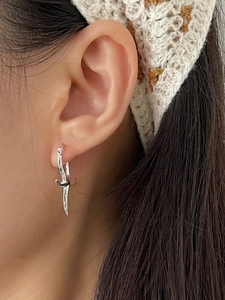 Detail of S925 sterling silver starfish drop earring worn on a model ear lobe