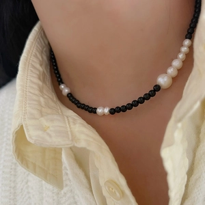 Elegant 925 black agate necklace with gradient pearls worn on neck over stylish shirt