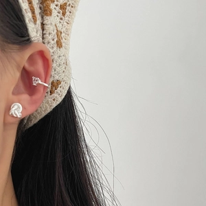 Elegant 925 sterling silver knot stud and crystal ear cuff set shown on a model