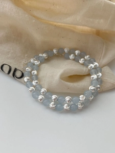 Detail of 925 silver beads and sapphire blue gems on a linen bag with extension chain