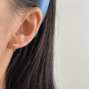 Minimalist 925 silver gold-plated hoop earrings with GOOD letter design on a model