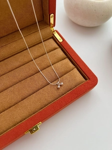 Detail of silver S925 necklace with dual sphere pendants in a luxury jewelry box