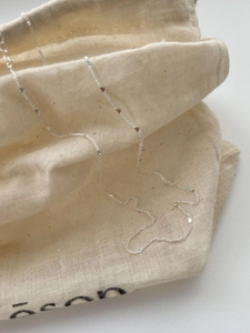 Close-up of minimalist 925 sterling silver chain necklace with small heart charms