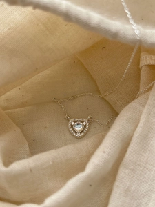 Detail of S925 sterling silver heart pendant with moonstone and braided texture