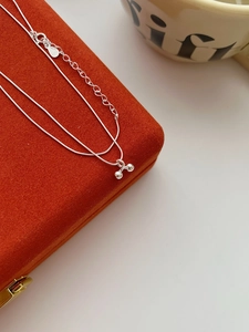 Macro shot of S925 sterling silver cherry pendant necklace with lobster clasp detail