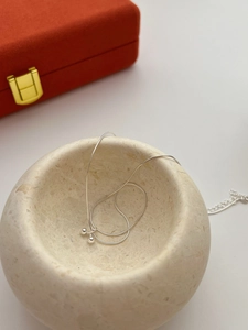 Detail of S925 sterling silver cherry pendant necklace on minimalist display stand