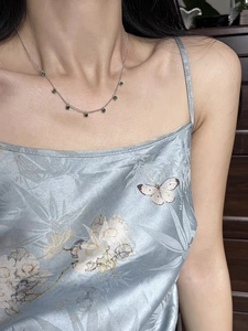 Detailed view of 925 silver necklace with green chalcedony beads on a female model