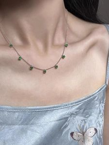 Detail of 925 silver necklace with green chalcedony beads on a female model
