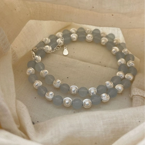 925 silver necklace featuring light blue beads and textured silver balls on linen