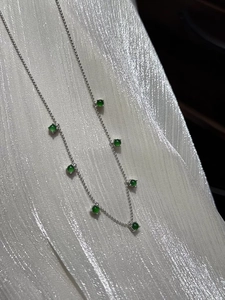Detailed view of S925 sterling silver chain with seven green chalcedony gemstone charms