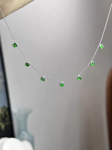 Detail of 925 sterling silver chain with seven round green chalcedony gemstones