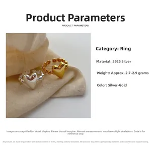 Detail of 925 sterling silver heart rings in silver and gold with bubble bead band