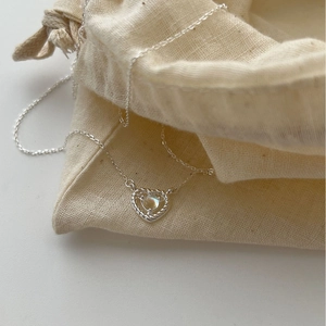 S925 sterling silver heart necklace with moonstone pendant and cream drawstring bag