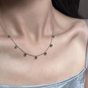 925 silver beaded necklace with seven round green chalcedony stones on model neck