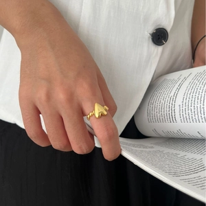 Golden 925 sterling silver heart ring with beaded band worn by a model on index finger