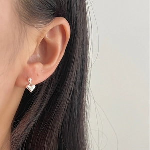 Minimalist S925 sterling silver heart bead earrings worn by a model in a side view
