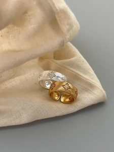 Detailed macro view of 925 silver brushed texture rings with star-shaped diamond accents