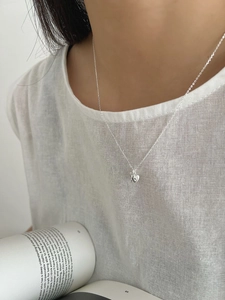 Close-up of minimalist S925 sterling silver heart key necklace on a model's neck