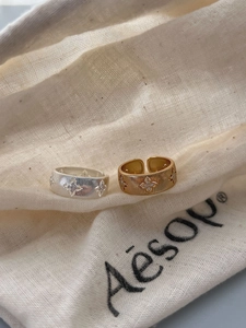 Detail of 925 sterling silver rings with Italian brushed texture and floral design