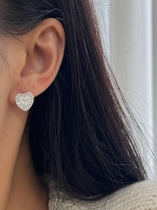 Close-up of S925 sterling silver heart stud earring with zircon and pleated texture