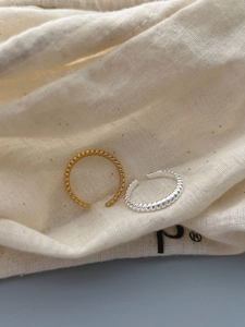 Detailed close-up of S925 sterling silver beaded rings in gold and silver finishes