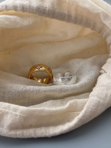 Macro shot of 925 silver retro rings with brushed texture and floral engraving