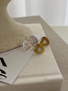 Detailed macro view of S925 sterling silver heart earrings with gold and silver finishes