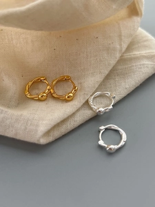 Detailed view of S925 silver hoop earrings with small beads in gold and silver finish