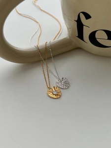 Close-up of heart-shaped pendant necklace with radiant texture and sparkling zircon stone